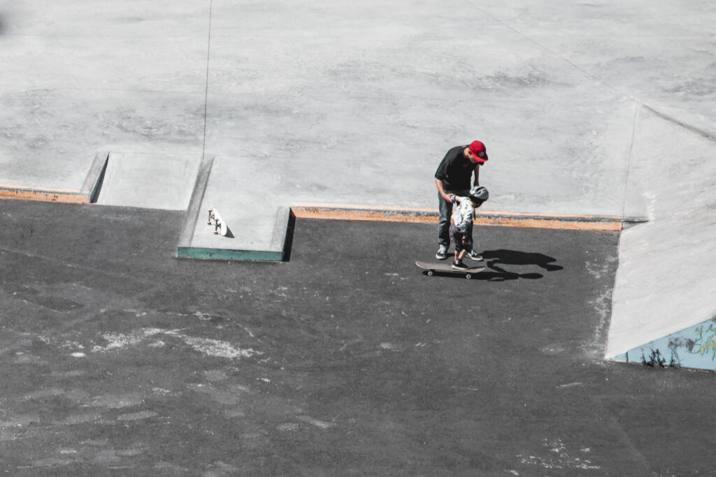 Skate with Jack teaching a child to skateboard